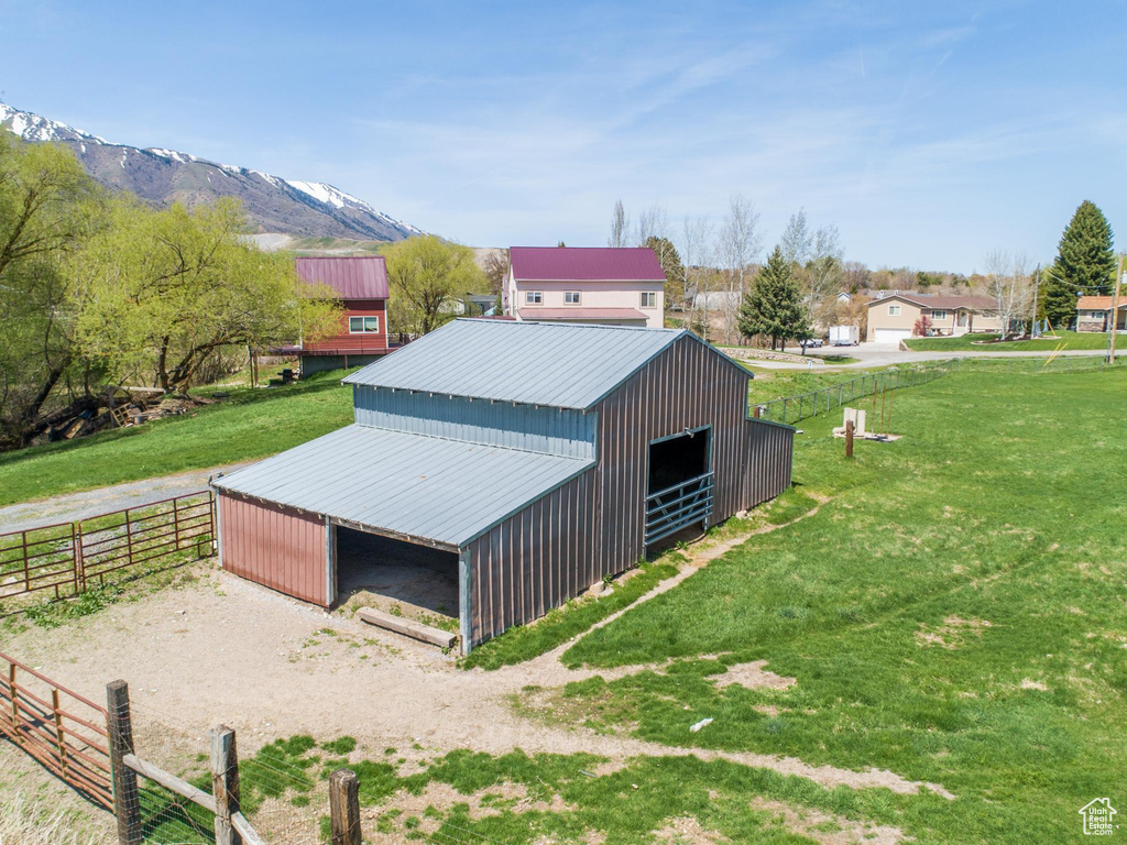 Exterior space featuring a mountain view, a yard, and an outdoor structure