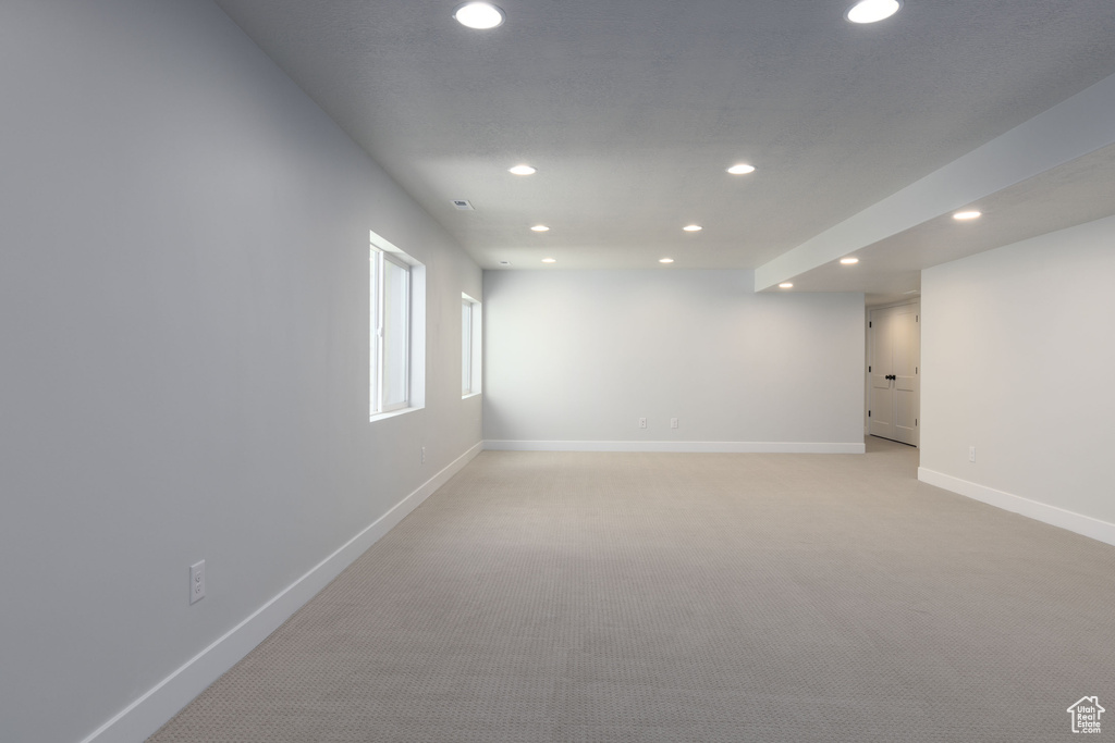 Empty room with light colored carpet