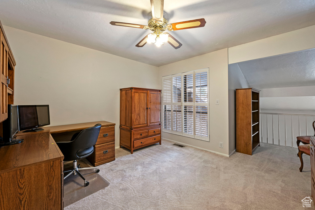 Carpeted home office with ceiling fan