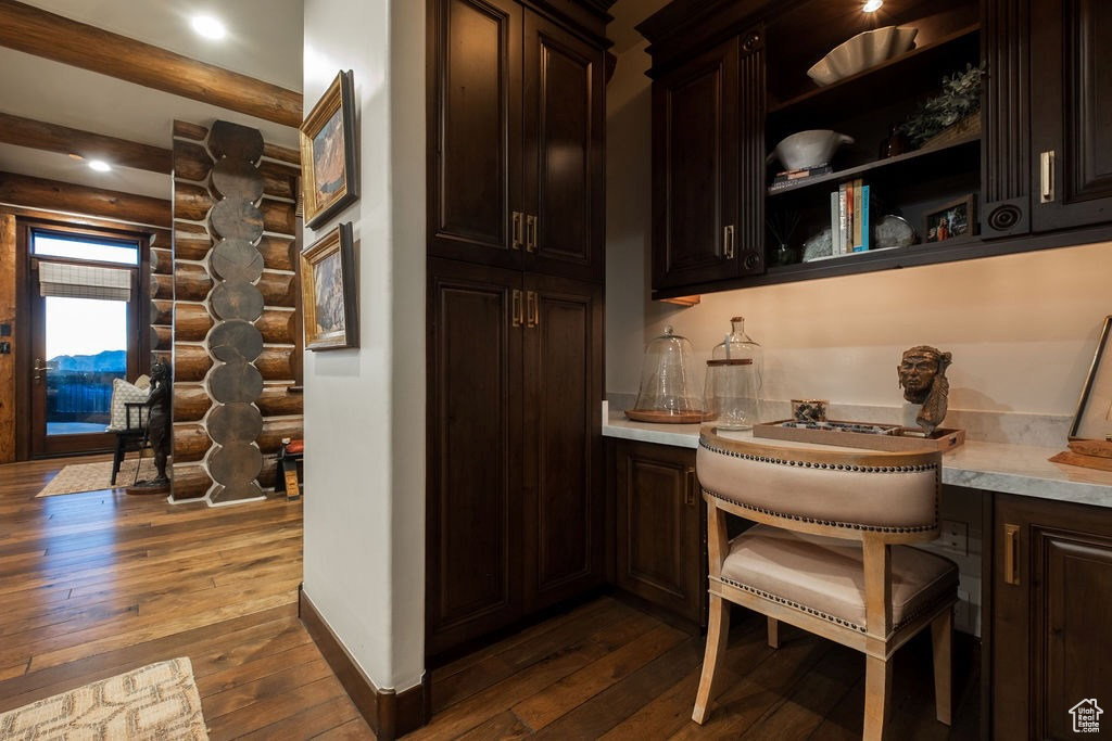 Kitchen with dark brown cabinetry and dark hardwood / wood-style floors