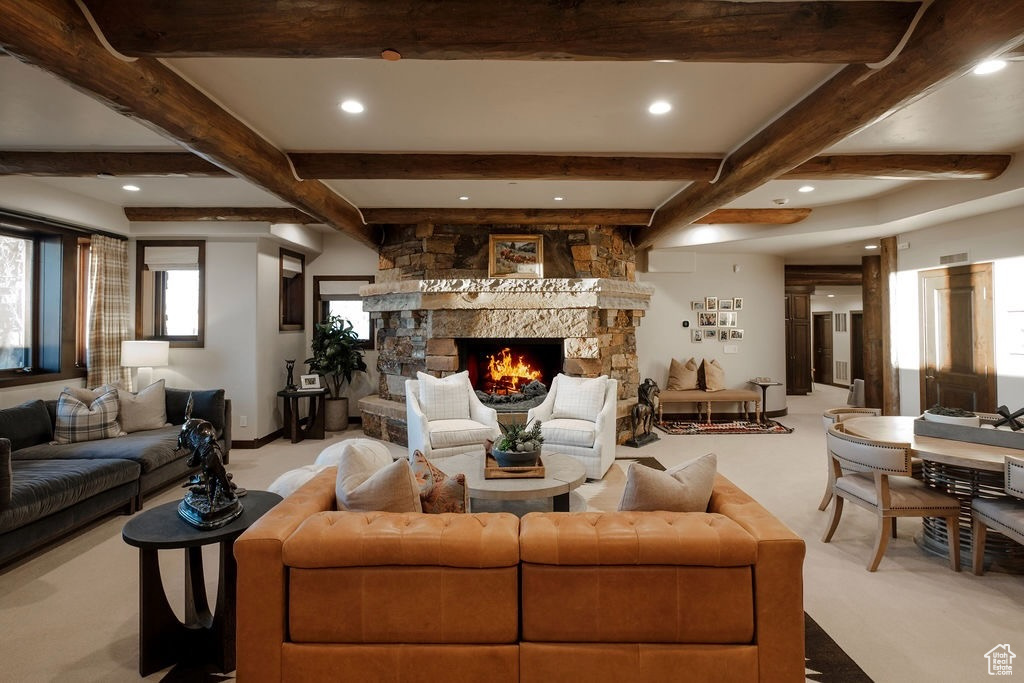 Living room with beam ceiling, carpet flooring, and a fireplace