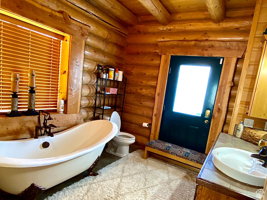 Bathroom featuring beam ceiling, rustic walls, wooden ceiling, and a washtub