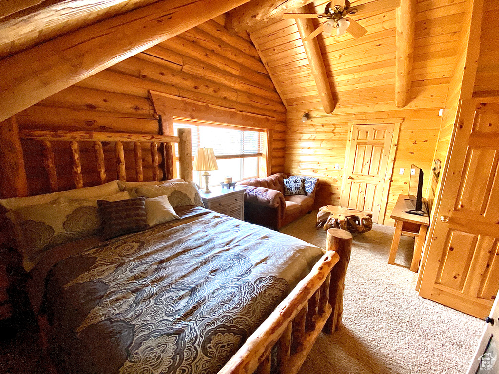 Bedroom featuring ceiling fan, wooden ceiling, carpet, and lofted ceiling with beams