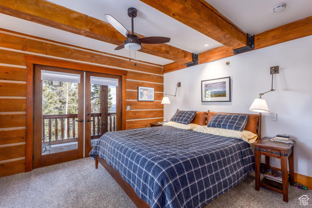 Carpeted bedroom featuring access to exterior, beamed ceiling, and ceiling fan
