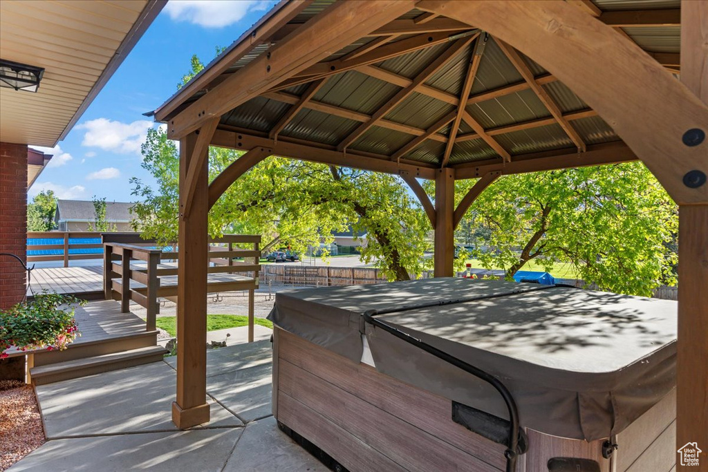 View of terrace featuring a gazebo and a hot tub