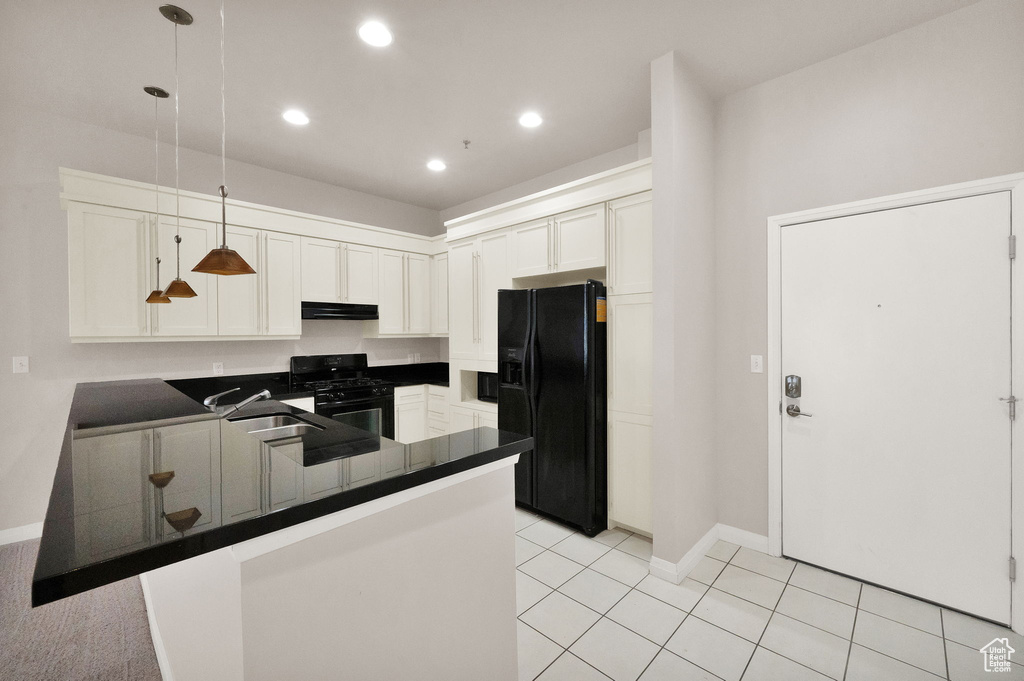 Kitchen with black appliances, white cabinetry, kitchen peninsula, and decorative light fixtures