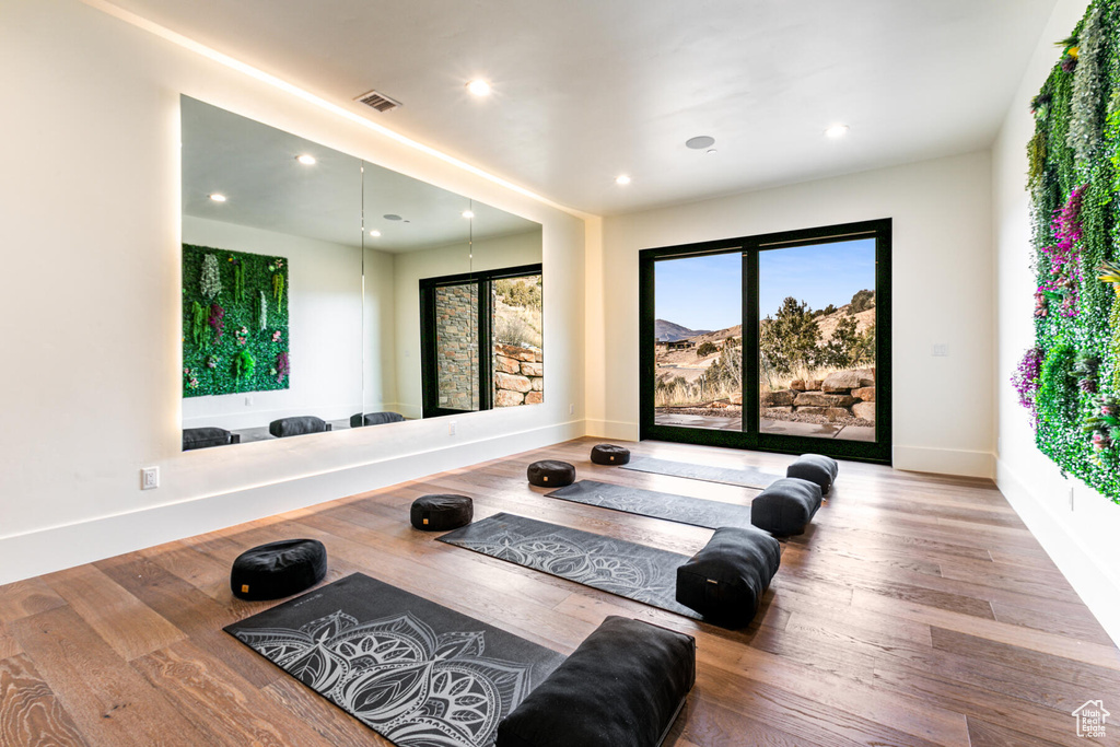 Workout area featuring light hardwood / wood-style floors