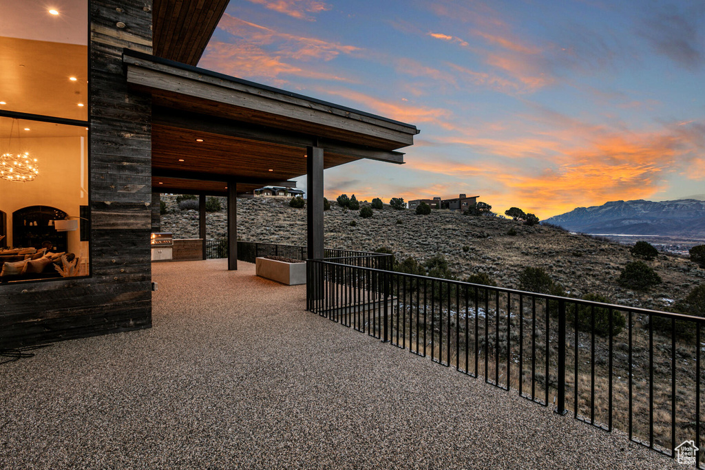 Patio terrace at dusk featuring a mountain view