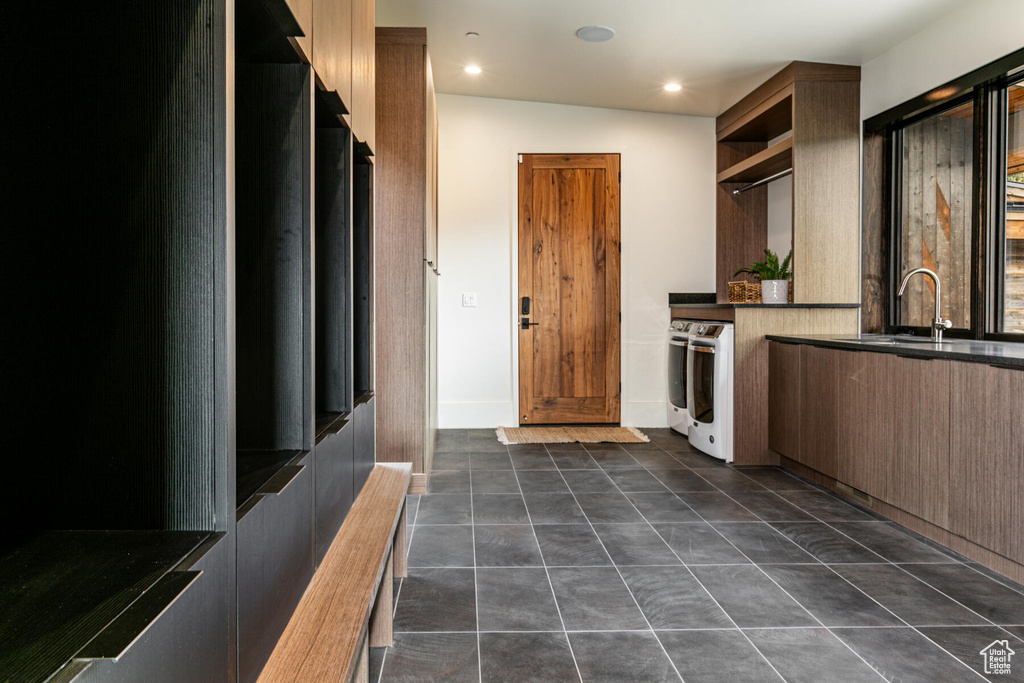 Kitchen featuring sink, vaulted ceiling, and dark tile floors