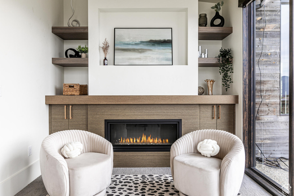 Sitting room featuring dark colored carpet