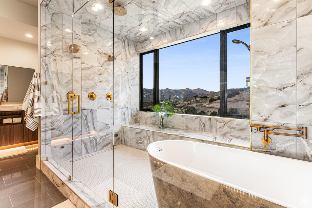 Bathroom featuring tile floors, a mountain view, and plus walk in shower