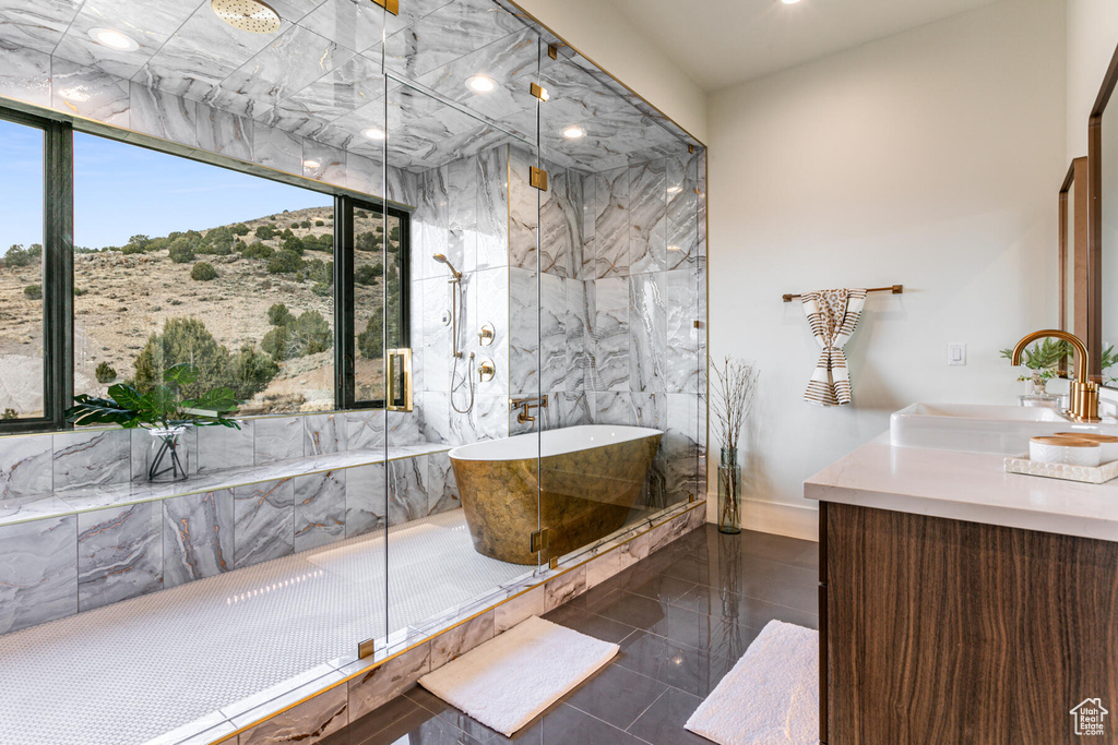 Bathroom with vanity, tile flooring, and shower with separate bathtub