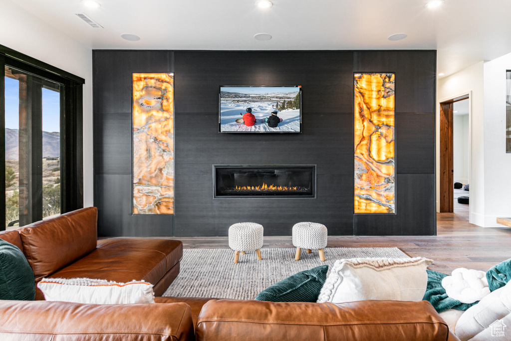 Living room with a wealth of natural light and light hardwood / wood-style floors