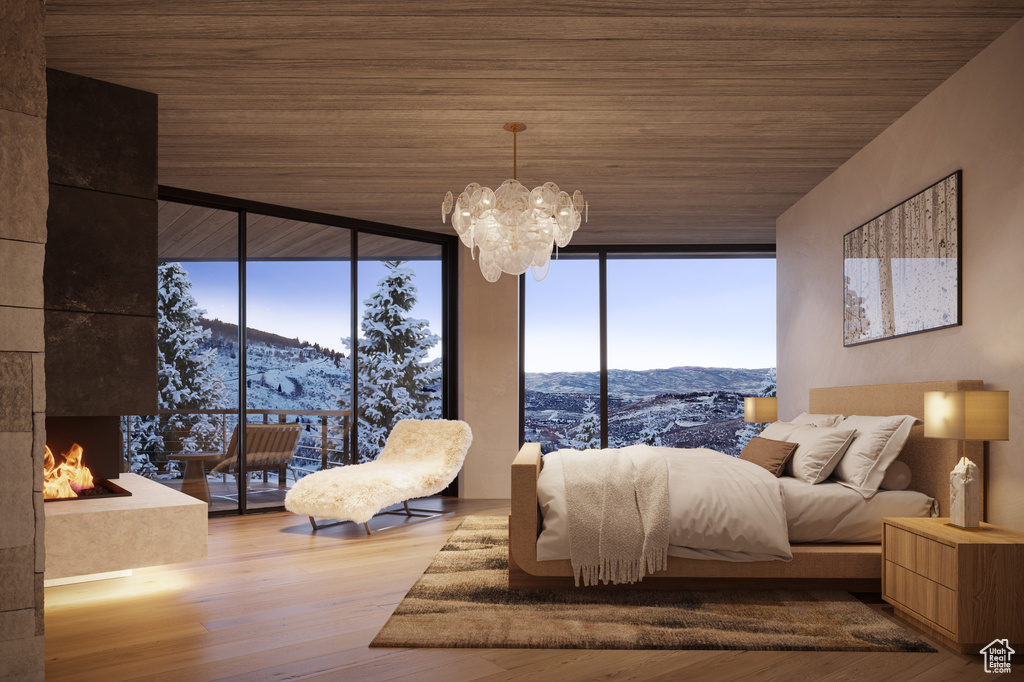 Bedroom featuring an inviting chandelier, wooden ceiling, a mountain view, hardwood / wood-style flooring, and floor to ceiling windows