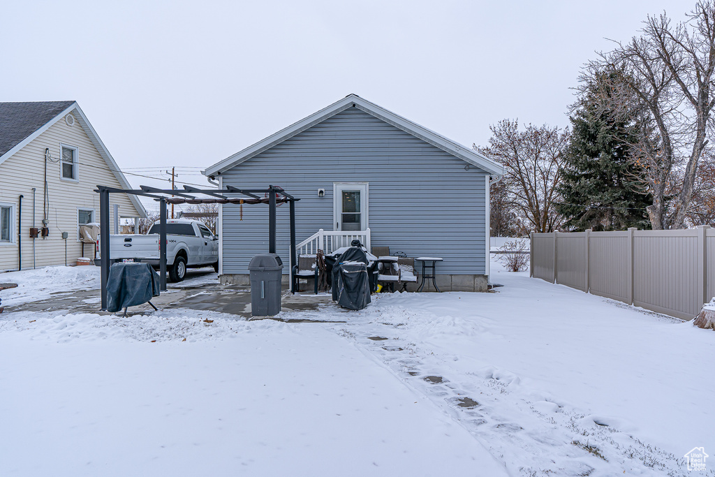 View of snow covered rear of property