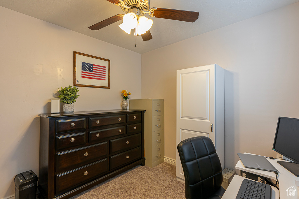 Office space with light colored carpet and ceiling fan