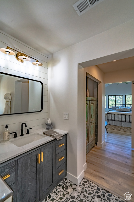 Bathroom featuring vanity, backsplash, and hardwood / wood-style floors