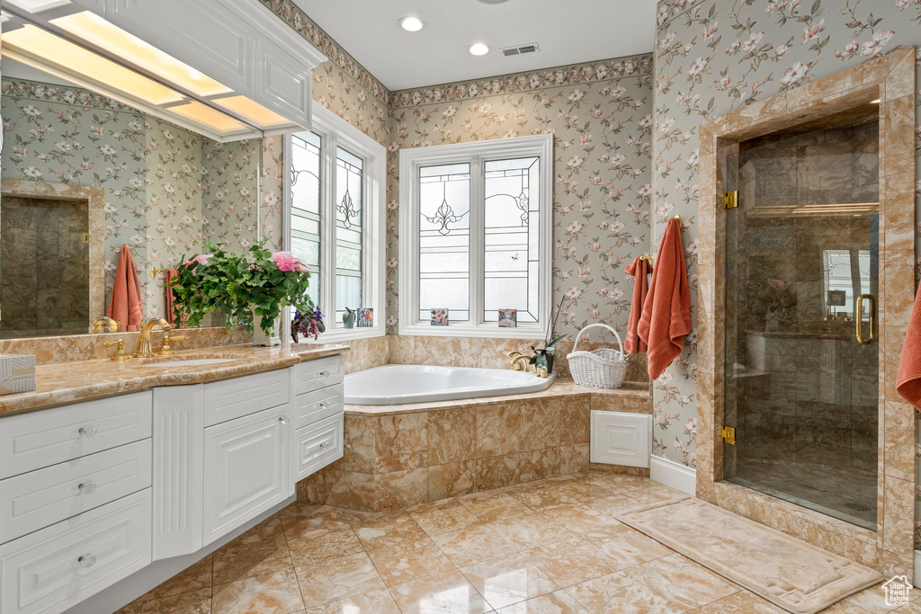 Bathroom with tile floors, separate shower and tub, and vanity with extensive cabinet space
