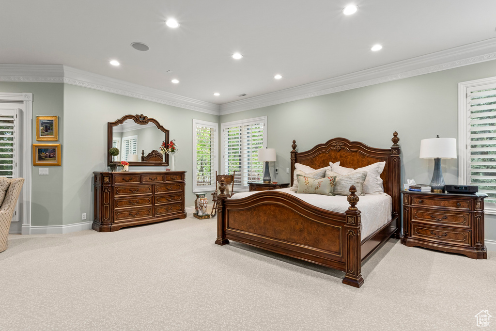 Bedroom featuring ornamental molding and light carpet