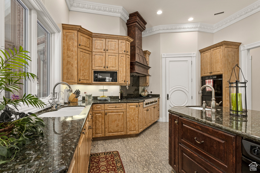 Kitchen featuring black appliances, crown molding, sink, and light tile floors