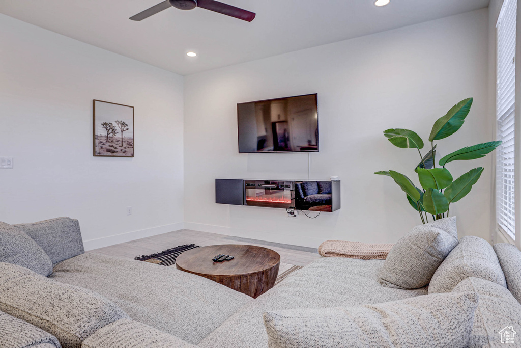 Living room featuring light wood-type flooring and ceiling fan