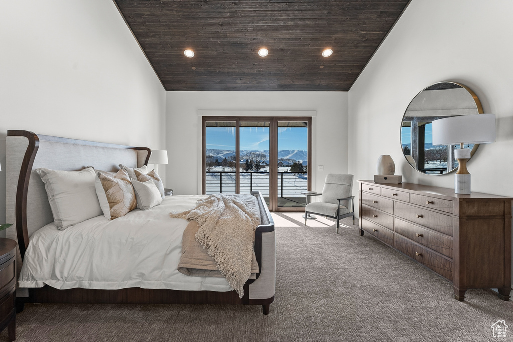 Bedroom featuring access to exterior, a mountain view, high vaulted ceiling, and dark colored carpet
