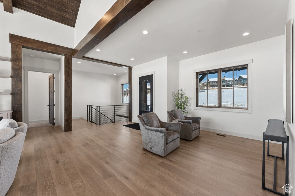 Interior space featuring beamed ceiling and light hardwood / wood-style floors