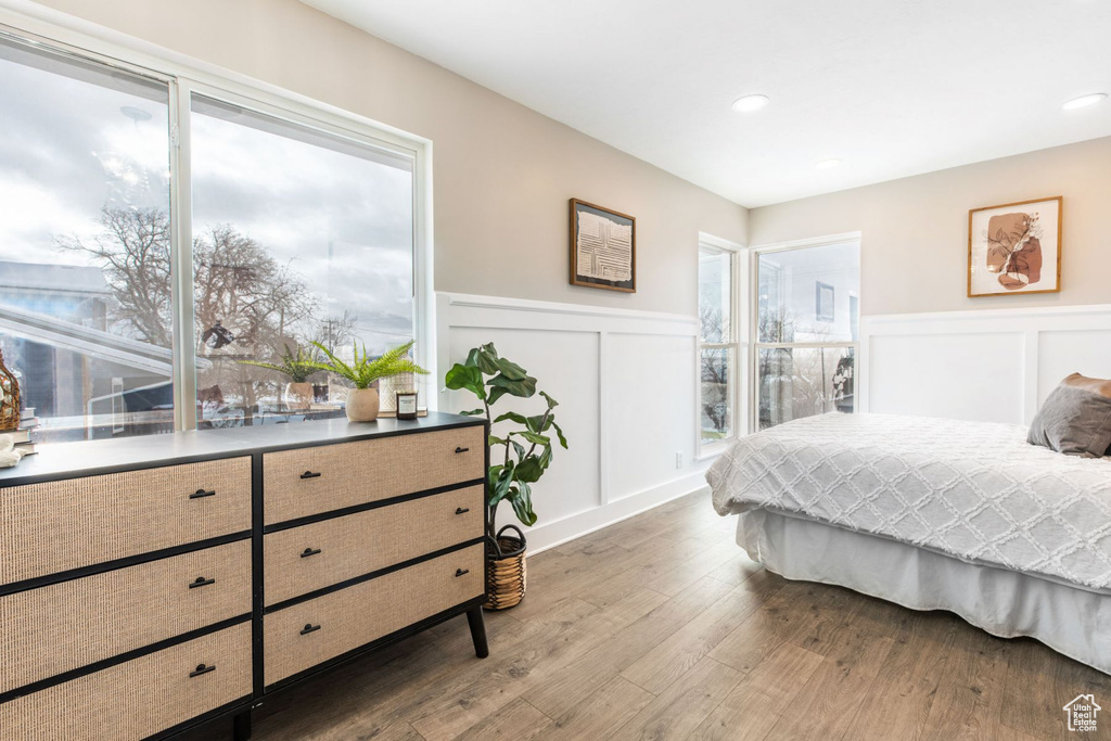 Bedroom with multiple windows and hardwood / wood-style flooring