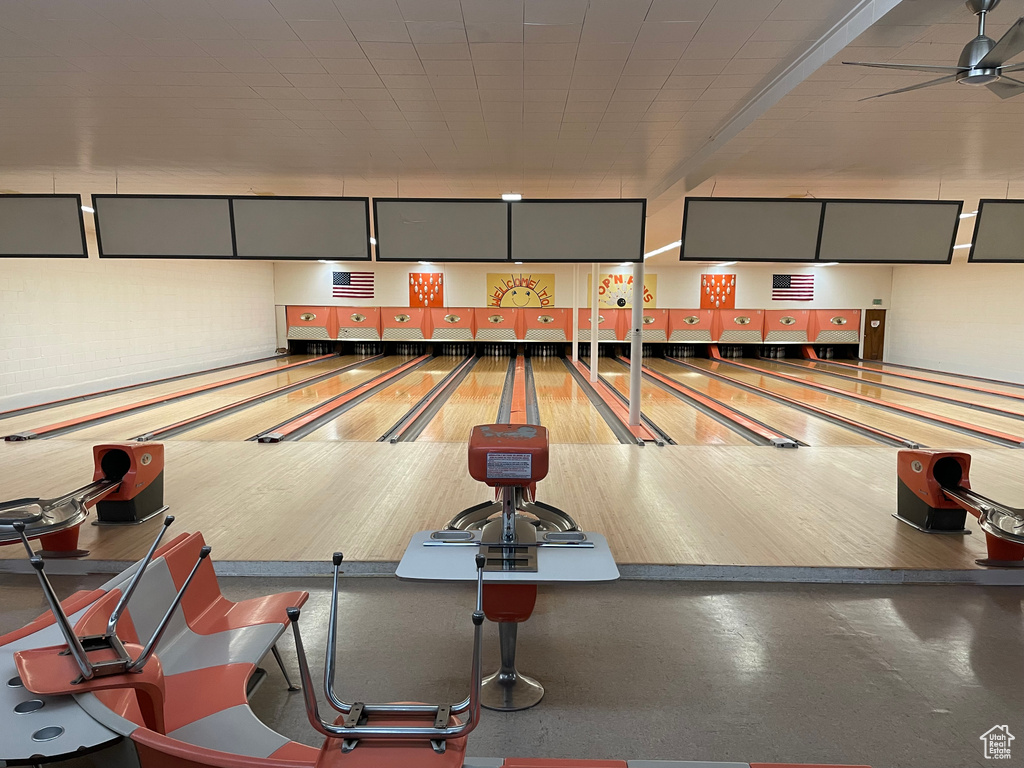 Recreation room with a bowling alley and ceiling fan