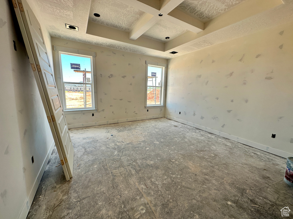 Unfurnished room featuring coffered ceiling and a textured ceiling