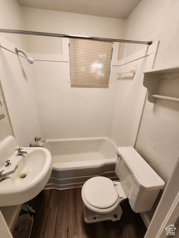 Full bathroom featuring sink, wood-type flooring, toilet, and shower / bathtub combination