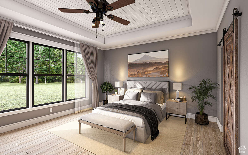 Bedroom featuring light wood-type flooring, a barn door, multiple windows, and ceiling fan