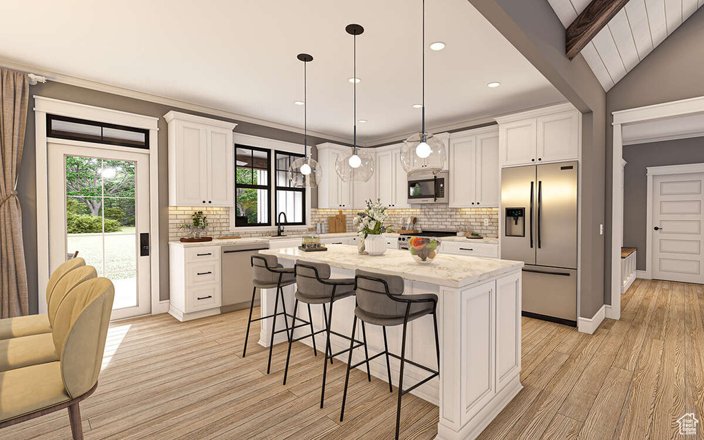 Kitchen with a kitchen island, tasteful backsplash, appliances with stainless steel finishes, decorative light fixtures, and light hardwood / wood-style flooring
