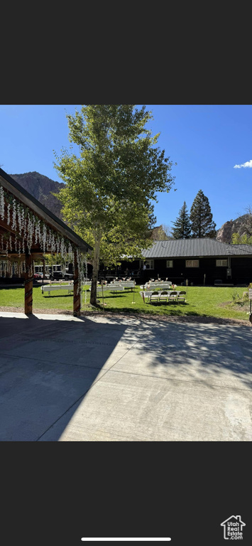 Exterior space featuring a lawn and a mountain view