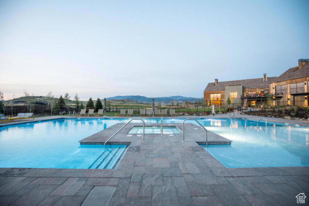 View of swimming pool featuring a patio and a mountain view