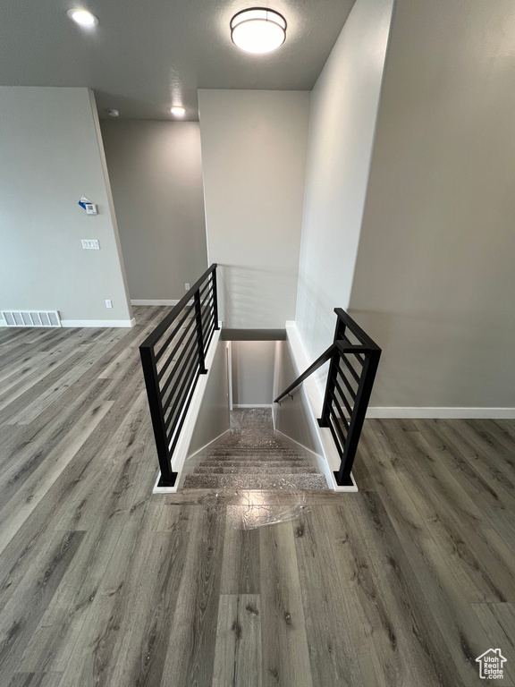 Stairs featuring dark hardwood / wood-style flooring
