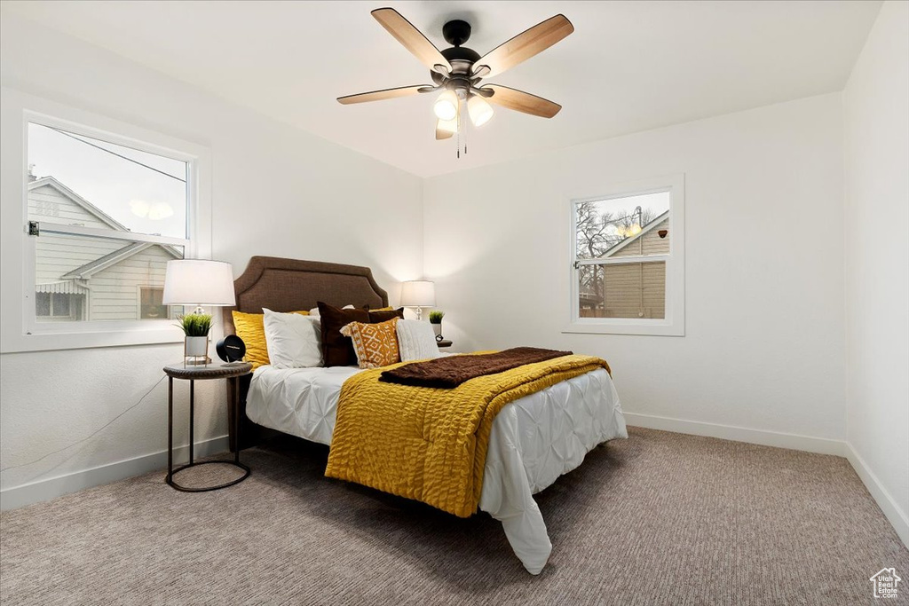 Carpeted bedroom featuring ceiling fan