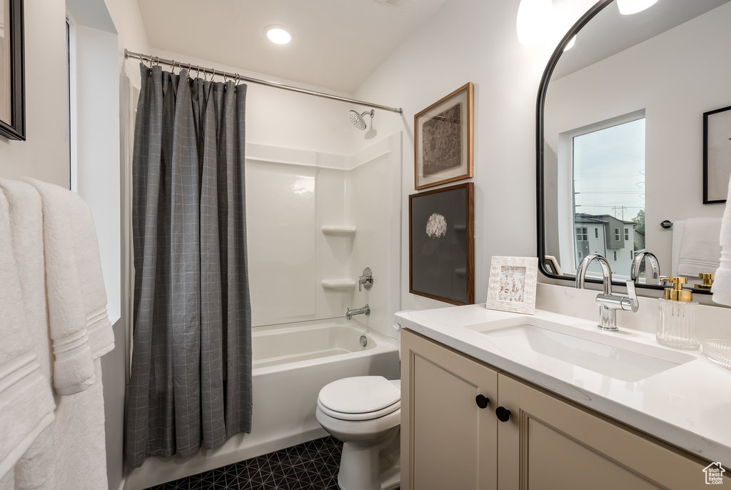 Full bathroom with shower / tub combo with curtain, toilet, tile flooring, and oversized vanity
