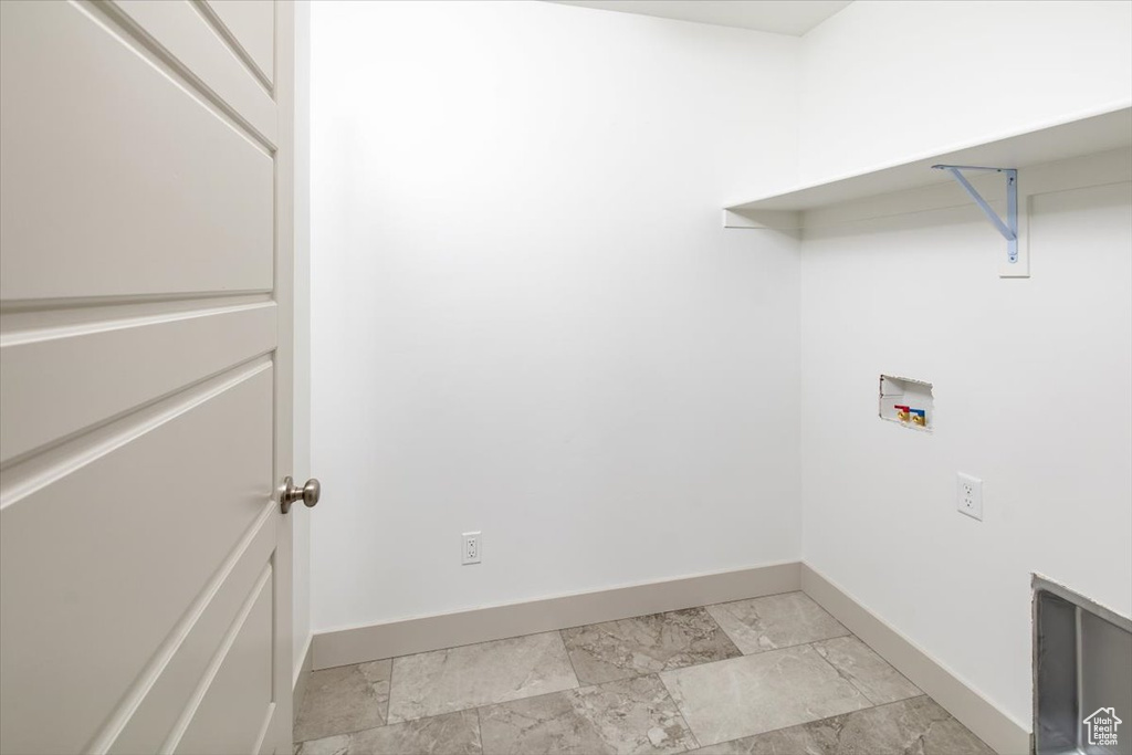 Laundry room with washer hookup and light tile flooring