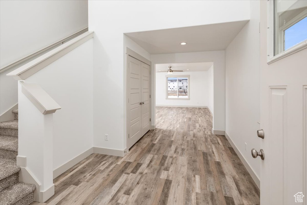Corridor featuring plenty of natural light and light hardwood / wood-style floors