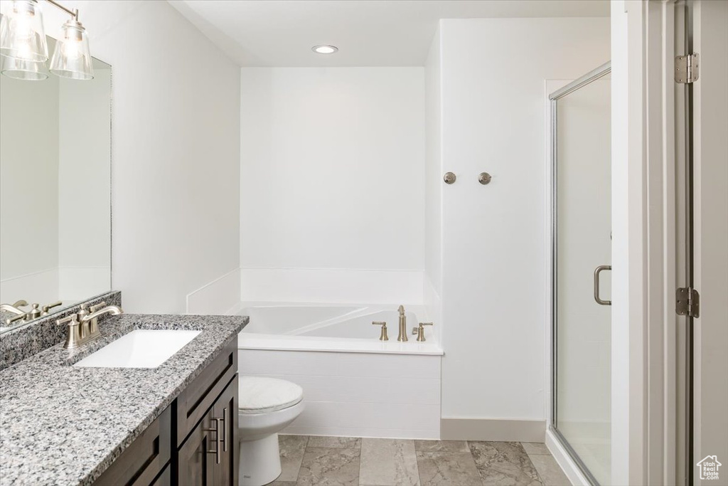 Full bathroom with toilet, vanity with extensive cabinet space, separate shower and tub, and tile flooring