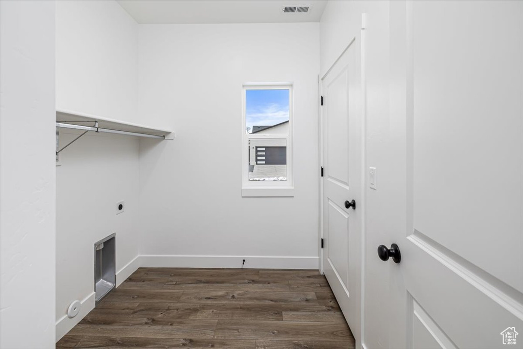 Laundry room featuring dark hardwood / wood-style flooring and hookup for an electric dryer