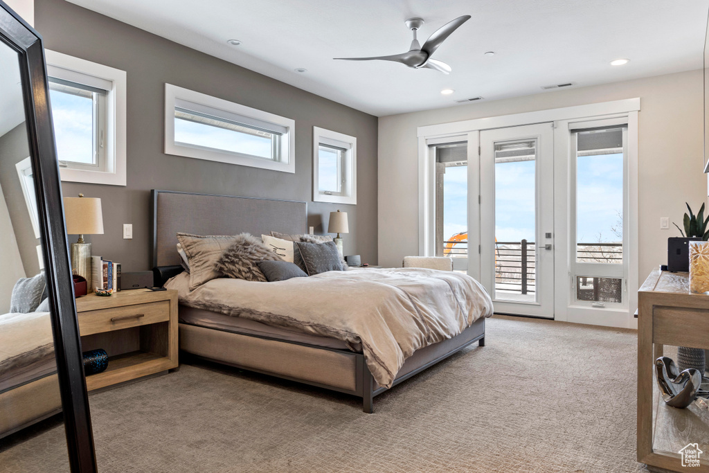 Bedroom featuring access to exterior, light carpet, and ceiling fan