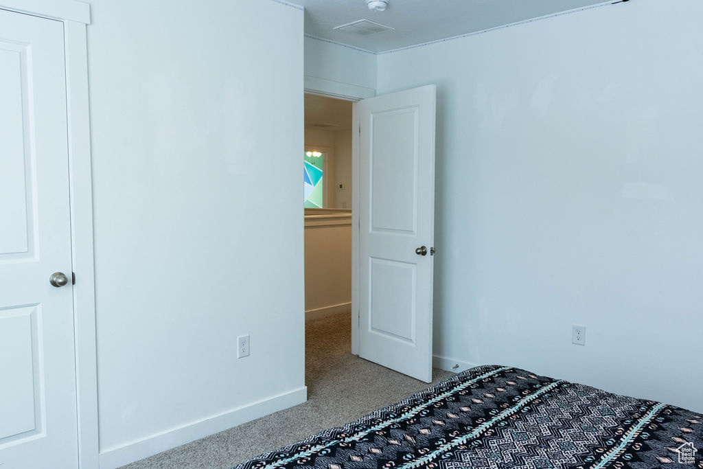 Unfurnished bedroom with light carpet