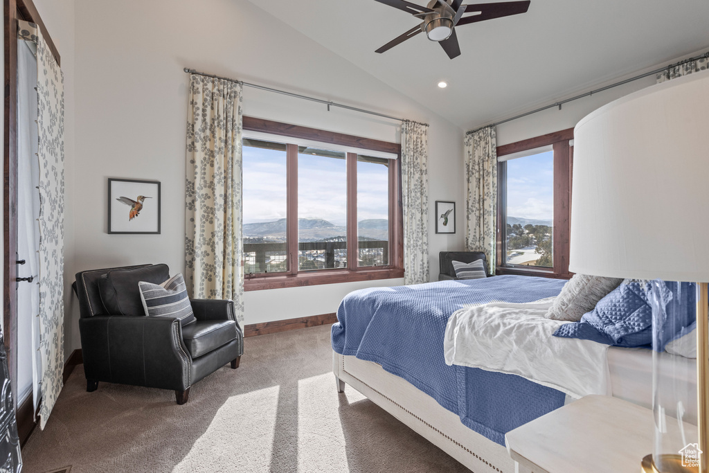 Bedroom featuring a mountain view, vaulted ceiling, carpet floors, and ceiling fan