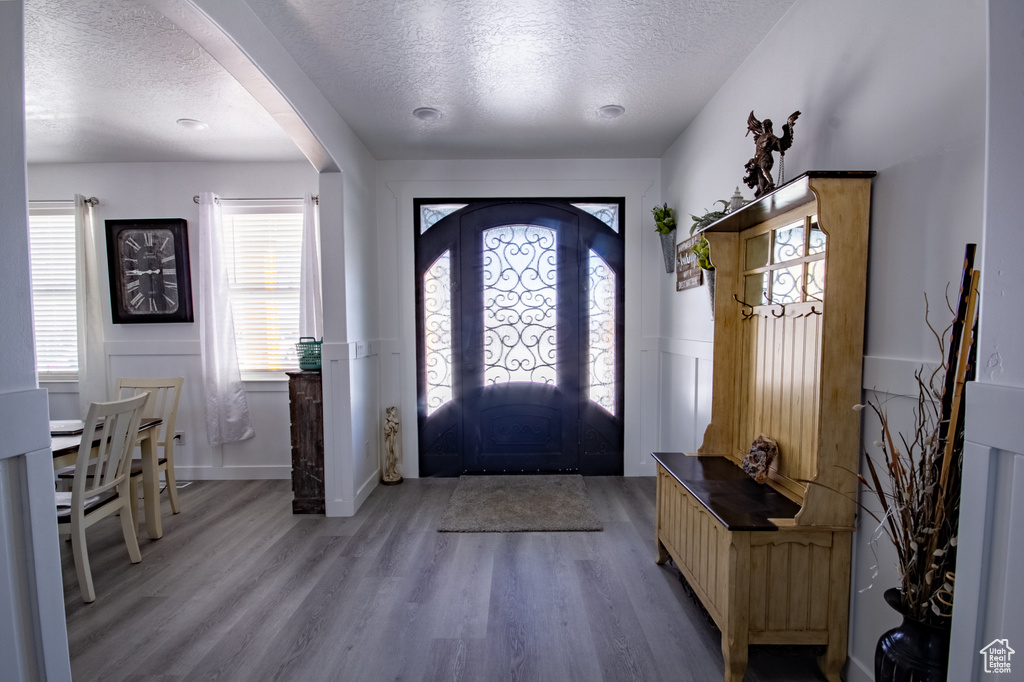 Foyer entrance featuring wood-type flooring and a textured ceiling