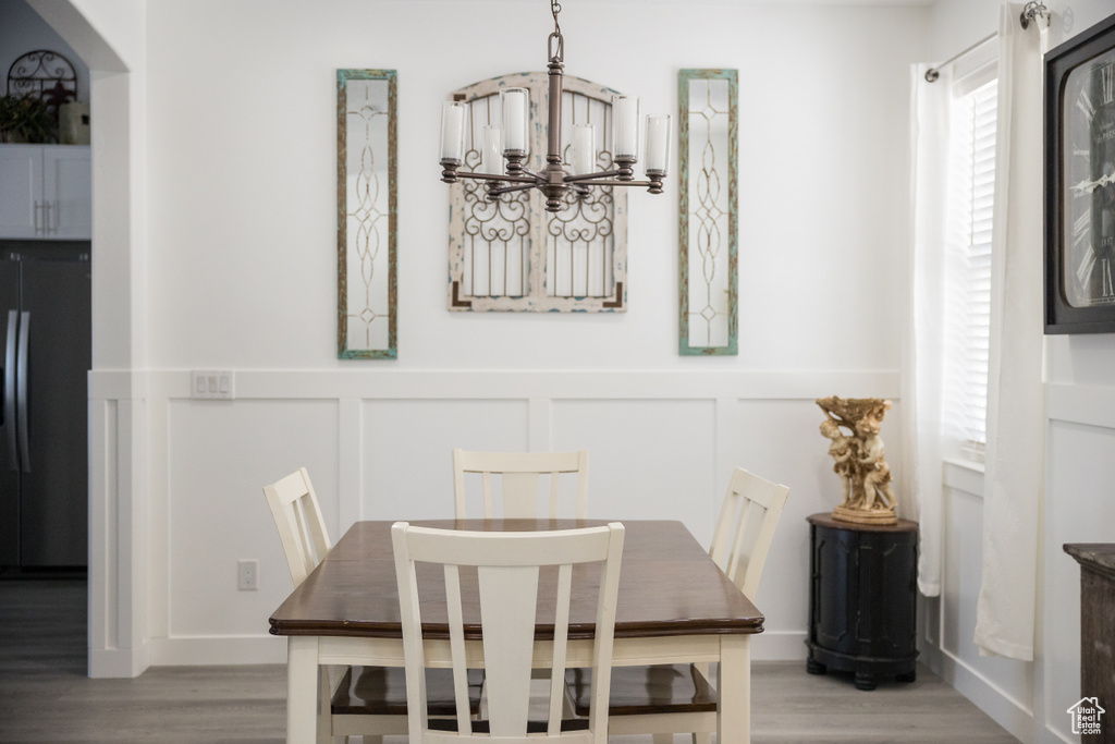 Dining space with an inviting chandelier and light hardwood / wood-style floors