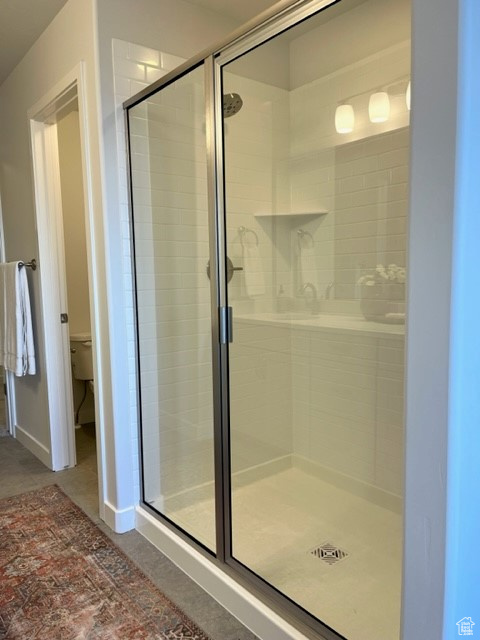 Bathroom featuring an enclosed shower and toilet