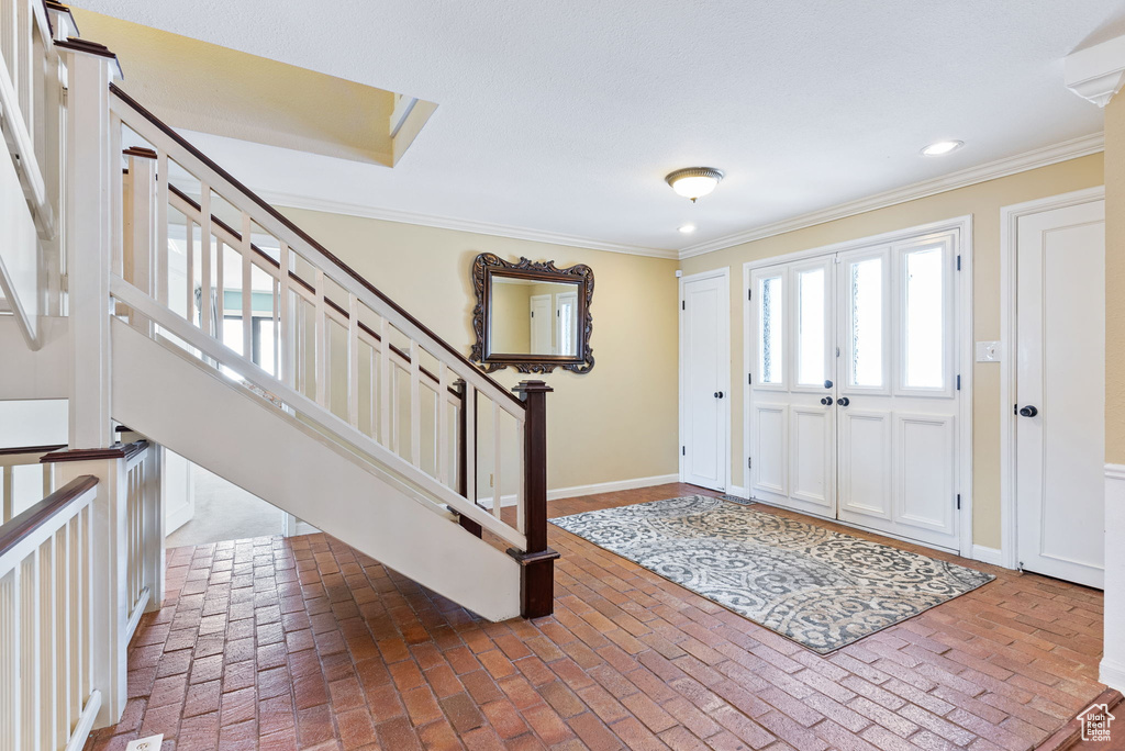Foyer featuring crown molding