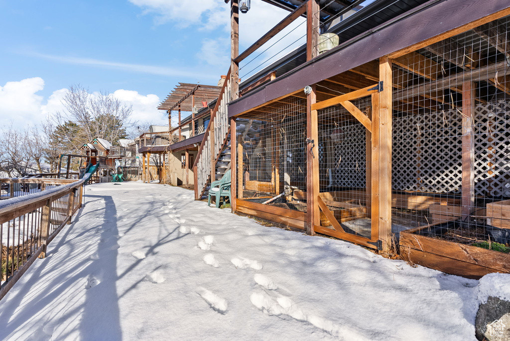 Snow covered patio with a playground